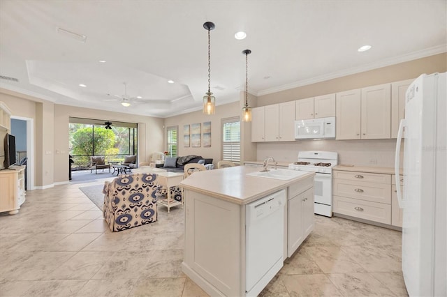 kitchen featuring white appliances, sink, an island with sink, and white cabinets