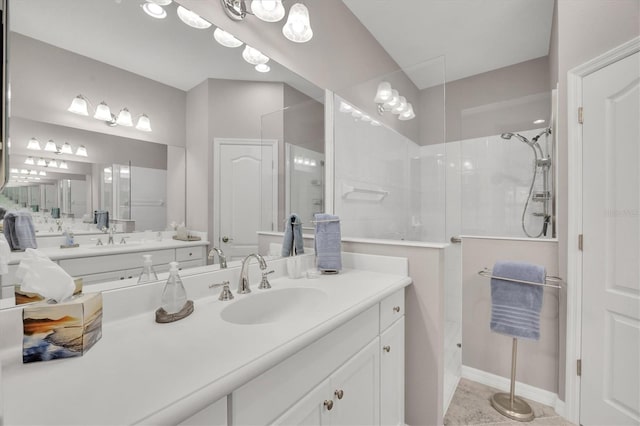 bathroom featuring vanity and tiled shower