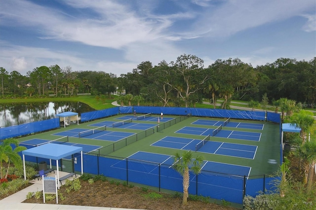 view of tennis court with a water view