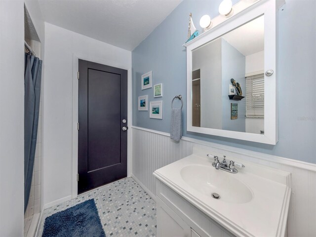 bathroom with vanity and curtained shower