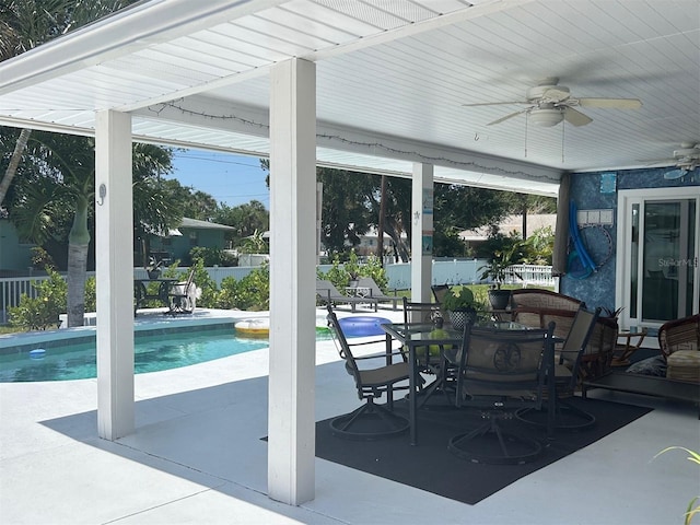 view of patio featuring ceiling fan and a fenced in pool