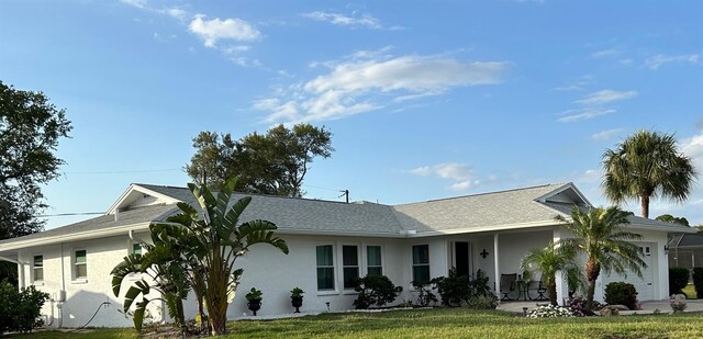 single story home featuring a garage and a front yard