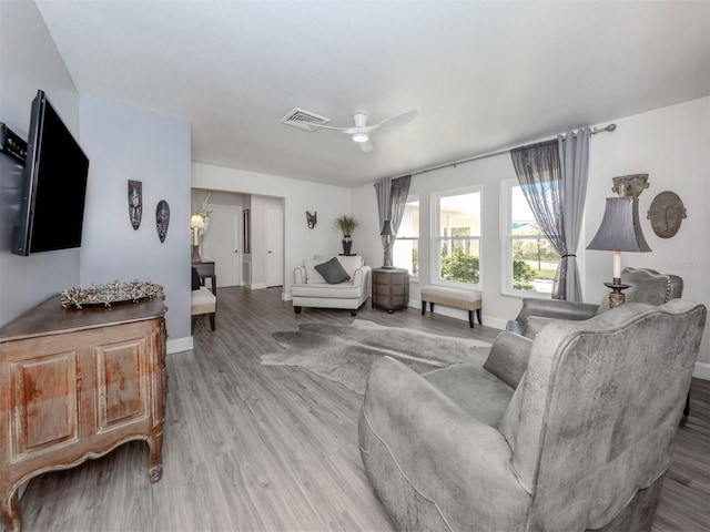 living room featuring ceiling fan and hardwood / wood-style floors