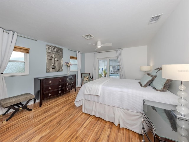 bedroom featuring access to outside, ceiling fan, and light wood-type flooring