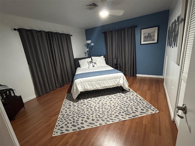 bedroom with dark wood-type flooring