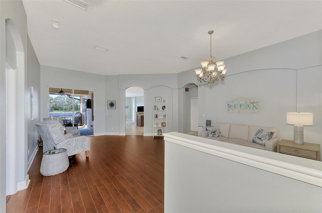 living room with hardwood / wood-style flooring and a chandelier