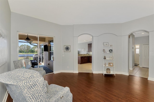 living room with light hardwood / wood-style flooring and ceiling fan