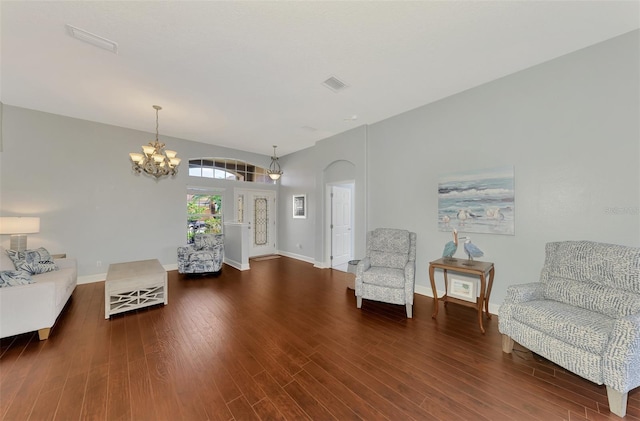 living area featuring an inviting chandelier and wood-type flooring