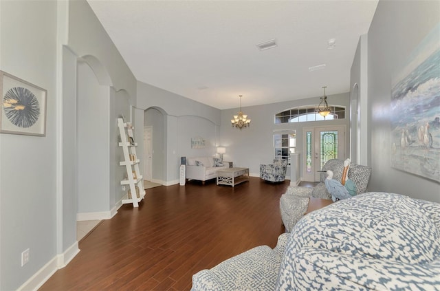 bedroom featuring a notable chandelier and dark hardwood / wood-style flooring