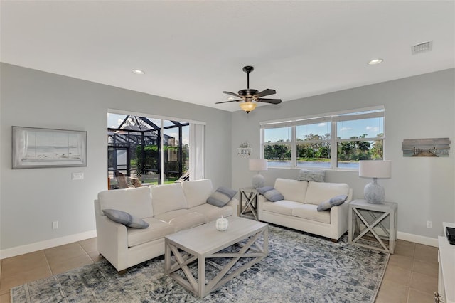 tiled living room with ceiling fan