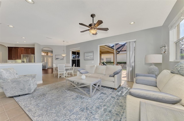 living room with ceiling fan and light tile patterned floors