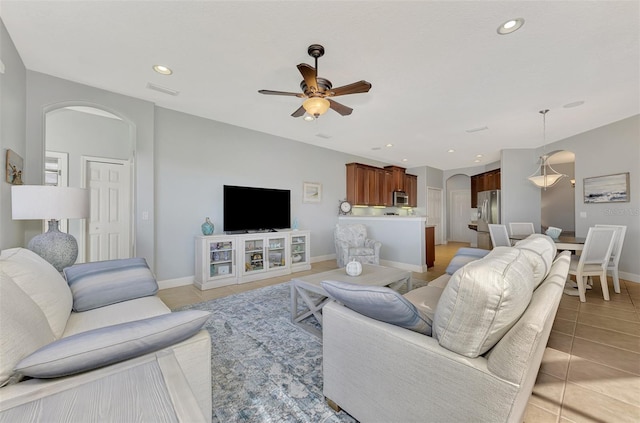 living room featuring light tile patterned flooring and ceiling fan