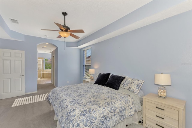 bedroom with connected bathroom, carpet floors, and ceiling fan