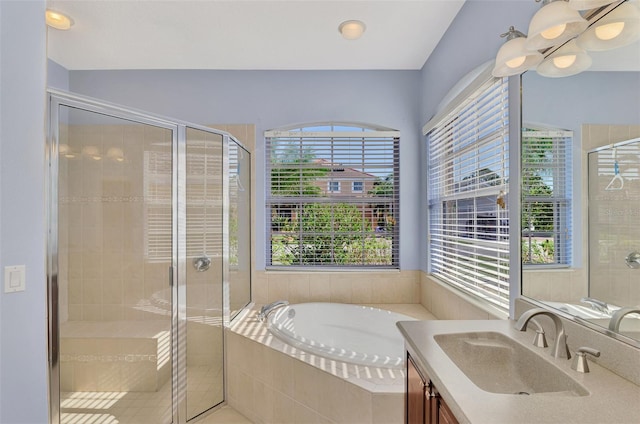 bathroom featuring vanity, a healthy amount of sunlight, and independent shower and bath