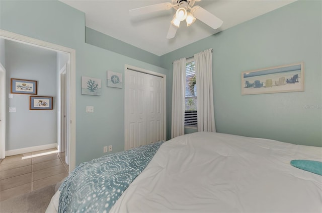 bedroom with a closet, ceiling fan, and tile patterned flooring