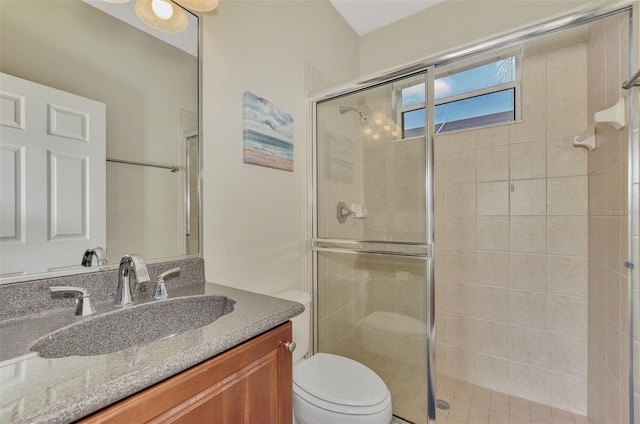 bathroom with vanity, an enclosed shower, and toilet