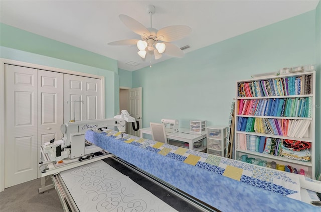 carpeted bedroom featuring a closet and ceiling fan