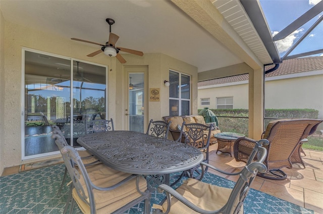 view of patio / terrace featuring ceiling fan and a lanai