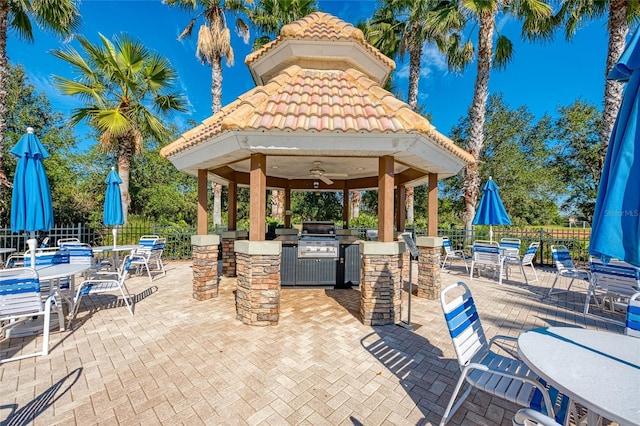 view of patio with a gazebo, a bar, and ceiling fan