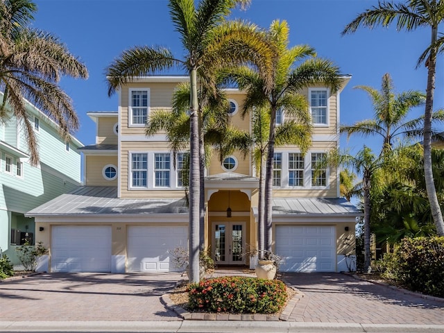 view of front of property with french doors and a garage