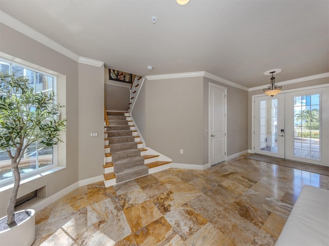 foyer with french doors, a wealth of natural light, and ornamental molding