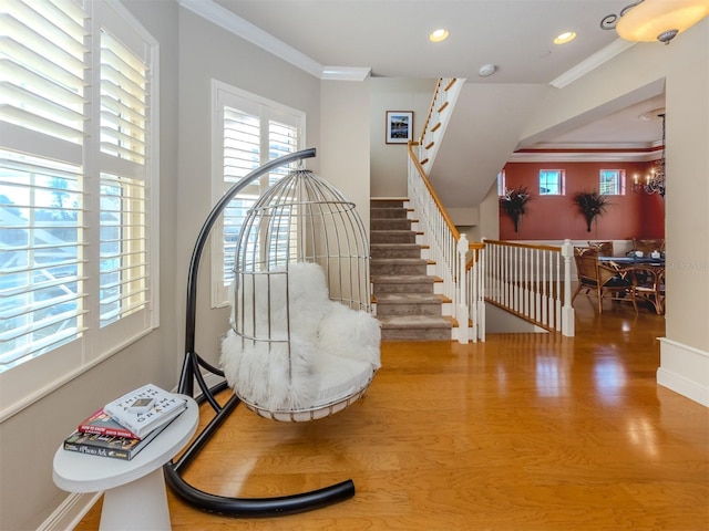 interior space featuring a chandelier, wood-type flooring, and ornamental molding