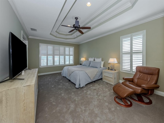 carpeted bedroom with a tray ceiling, ceiling fan, and crown molding