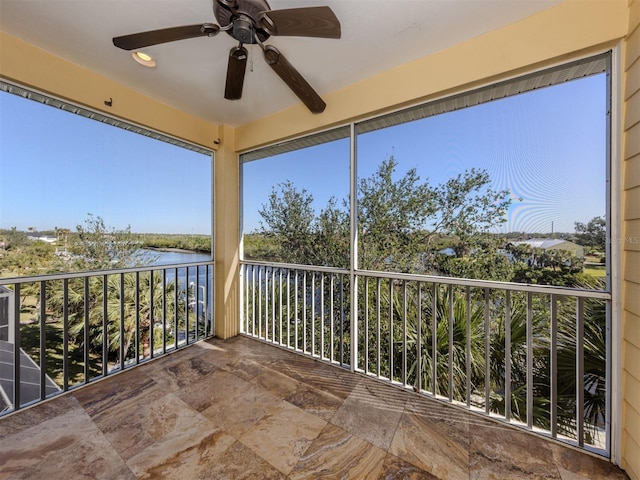 exterior space featuring ceiling fan and a water view