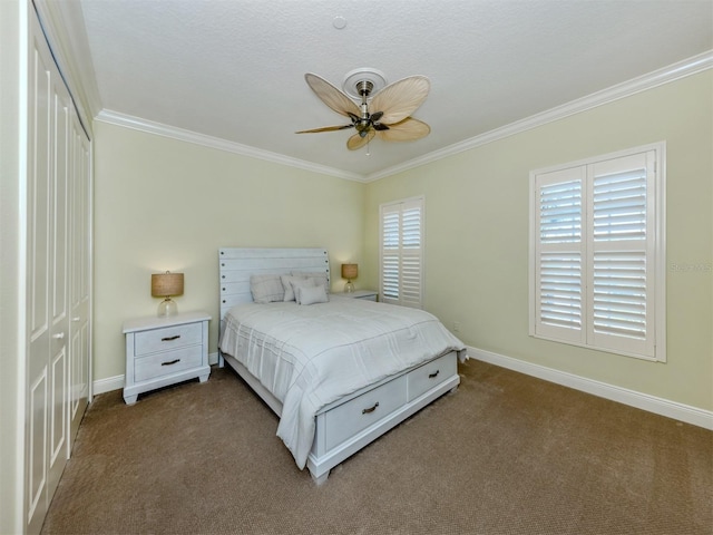 carpeted bedroom with a textured ceiling, a closet, ceiling fan, and crown molding