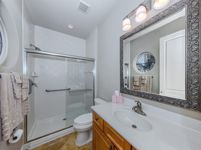 bathroom featuring vanity, toilet, and an enclosed shower