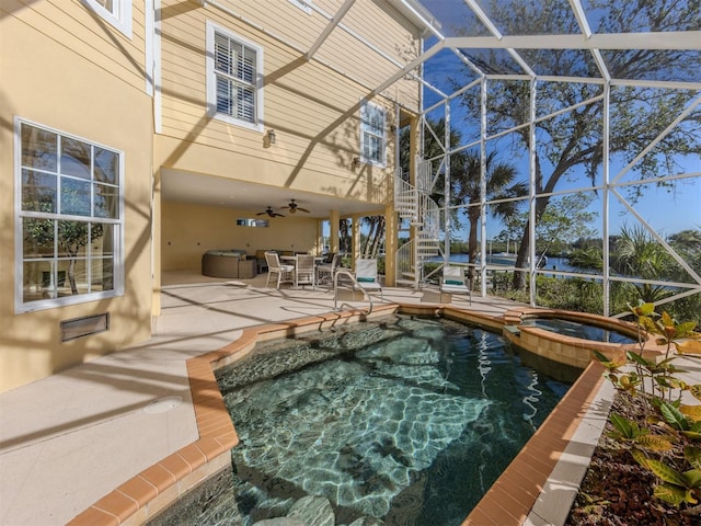 view of pool featuring a lanai, an in ground hot tub, ceiling fan, and a patio