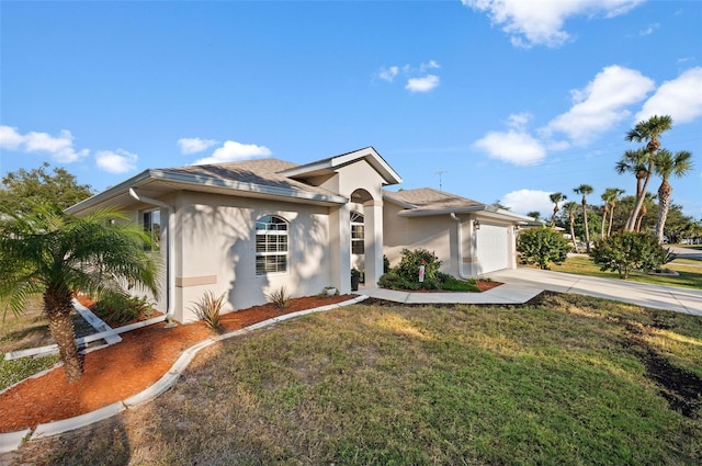 view of front of home with a front yard and a garage