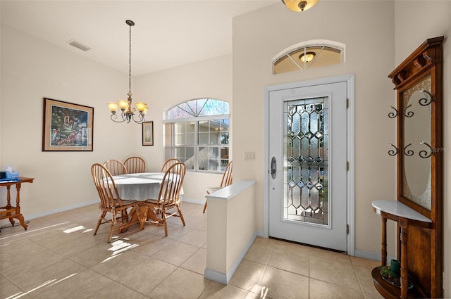 tiled foyer with a notable chandelier