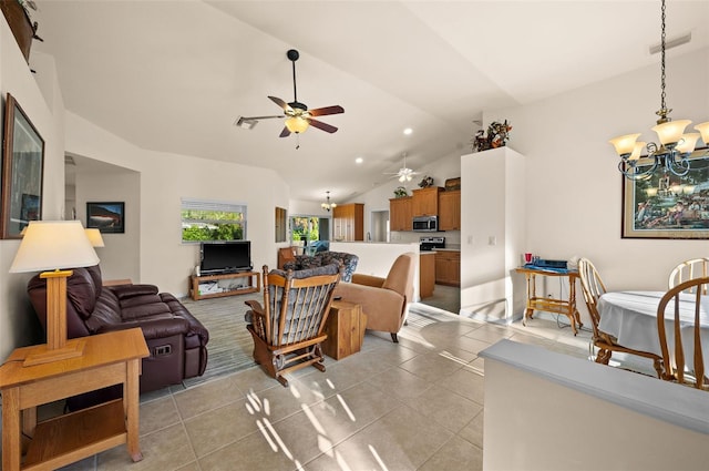 tiled living room featuring vaulted ceiling and ceiling fan with notable chandelier