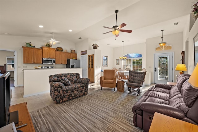 living room with light tile patterned flooring, high vaulted ceiling, and ceiling fan with notable chandelier