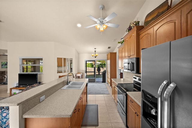 kitchen featuring sink, an island with sink, stainless steel appliances, and light tile patterned flooring