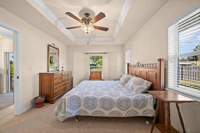 carpeted bedroom with ornamental molding, access to exterior, a raised ceiling, and ceiling fan