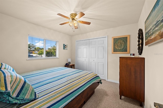 bedroom with light carpet, a closet, and ceiling fan