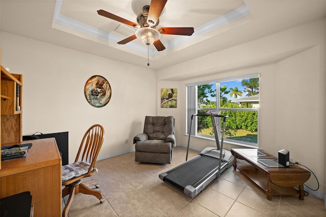 tiled home office featuring crown molding, ceiling fan, and a raised ceiling