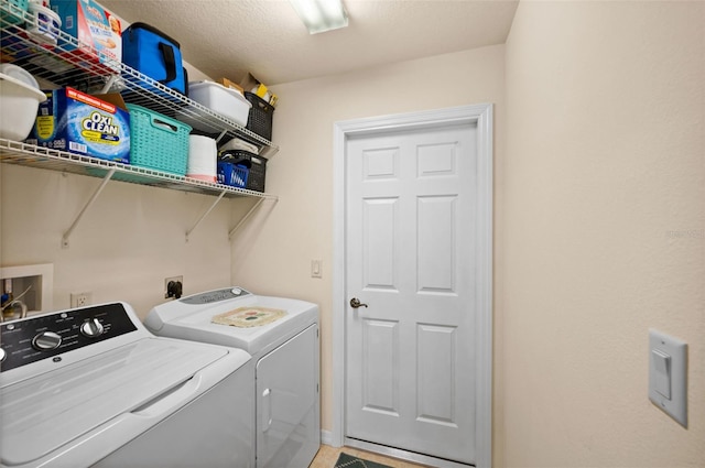 laundry area featuring a textured ceiling and separate washer and dryer