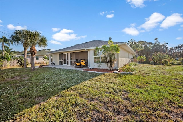 rear view of property with a patio area and a lawn