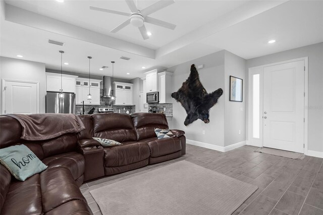8559 Waldrep St, Port Charlotte, FL 33981 - living area featuring baseboards, a ceiling fan, recessed lighting, and wood finished floors