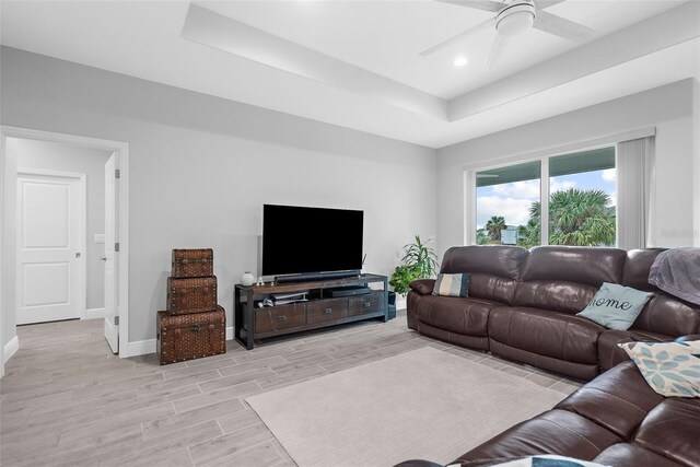 8559 Waldrep St, Port Charlotte, FL 33981 - living room with a raised ceiling, light wood-style floors, baseboards, a ceiling fan, and recessed lighting