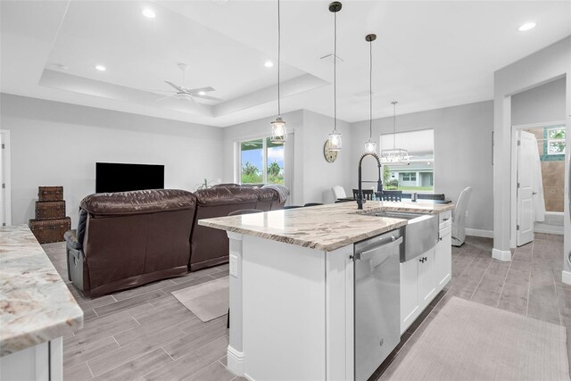 8559 Waldrep St, Port Charlotte, FL 33981 - kitchen featuring stainless steel dishwasher, a sink, white cabinets, light stone countertops, and wood finish floors