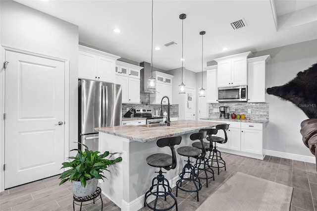8559 Waldrep St, Port Charlotte, FL 33981 - kitchen with stainless steel appliances, glass insert cabinets, wood finish floors, decorative backsplash, and recessed lighting