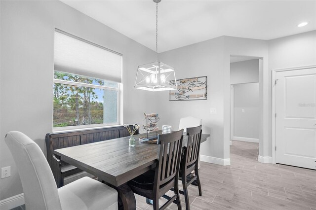 8559 Waldrep St, Port Charlotte, FL 33981 - dining area featuring a chandelier, baseboards, light wood-type flooring, and recessed lighting