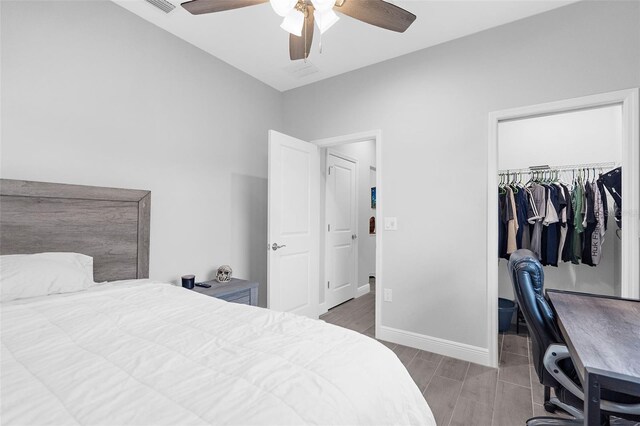 8559 Waldrep St, Port Charlotte, FL 33981 - bedroom with a walk in closet, an office area, baseboards, a closet, and a ceiling fan