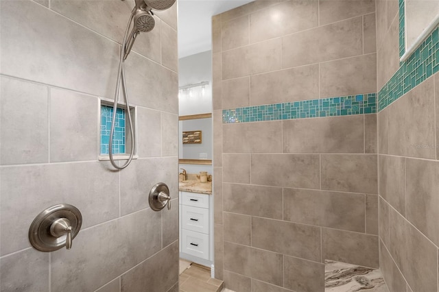 bathroom featuring vanity and a tile shower