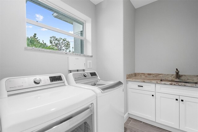 8559 Waldrep St, Port Charlotte, FL 33981 - washroom with washer and clothes dryer and cabinet space