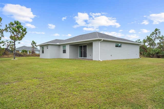 back of property featuring a yard